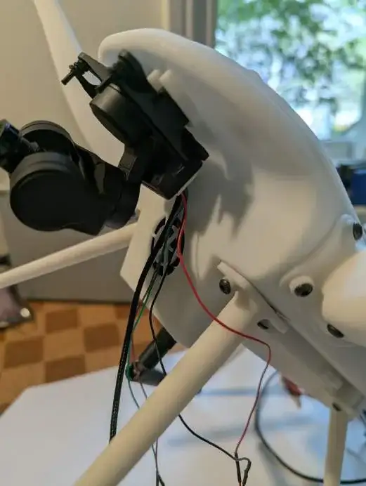 The printed frame with a camera gimbal fitted, opened up to show the wiring.