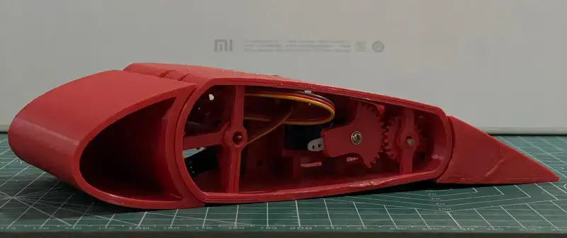 The red printed airfoil on a cutting mat during assembly.