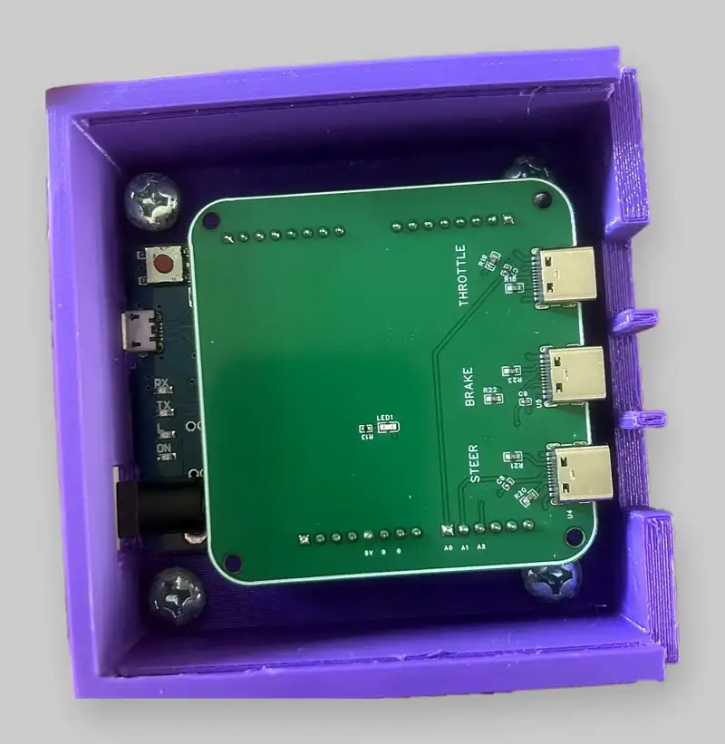 The custom shield board in its printed case, with USB-C sockets for throttle, brake and steering.