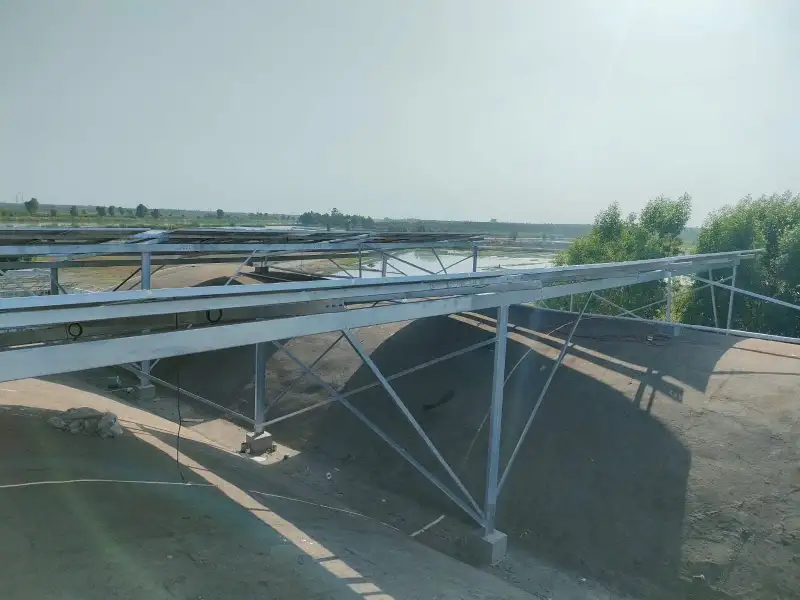 The galvanised steel frames standing over the curved roofs, before the panels went on.