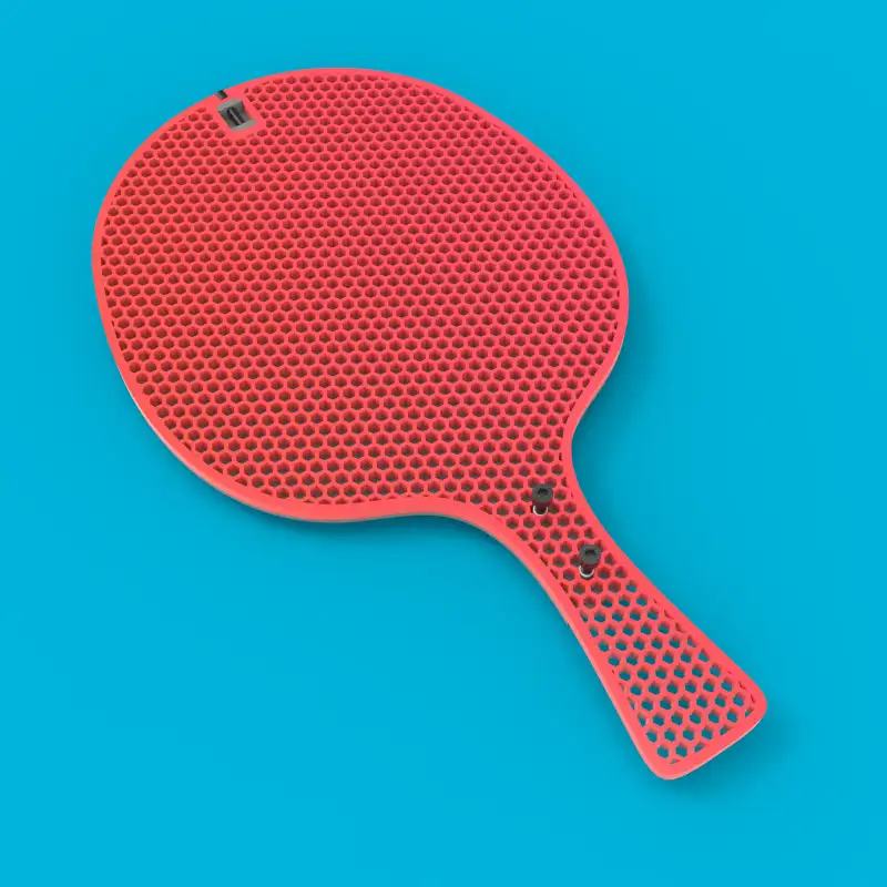 Red paddle face with a perforated pattern.